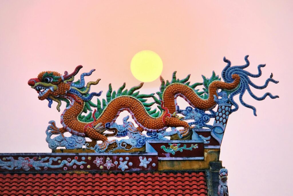 free-photo-of-moon-over-a-traditional-chinese-dragon-shaped-roof-decoration
